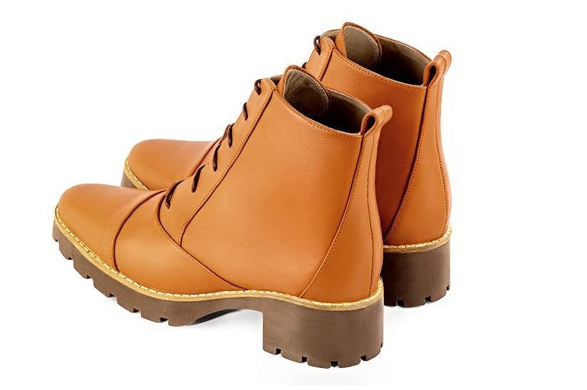 Marigold orange women's ankle boots with laces at the front. Round toe. Low rubber soles. Rear view - Florence KOOIJMAN